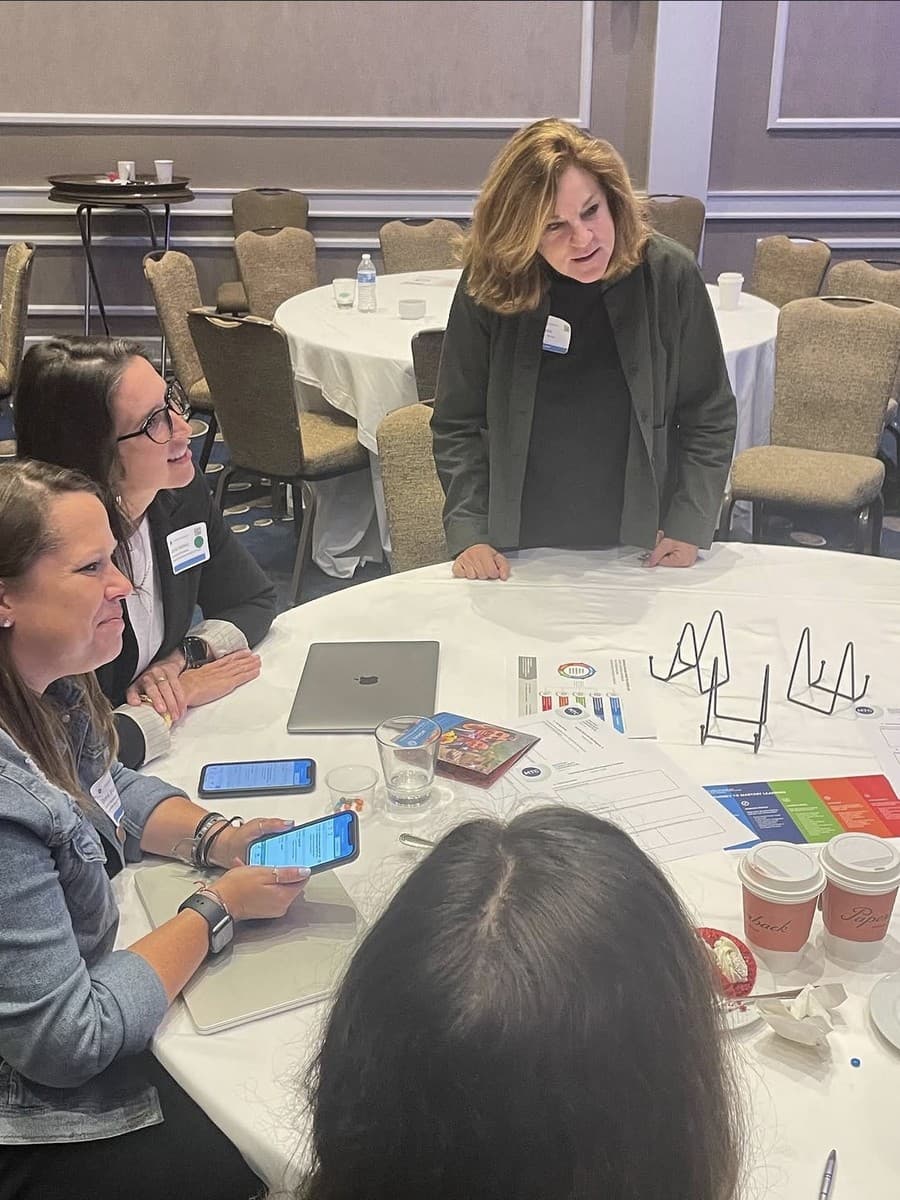 School leaders working together around a table at a Mastery.org session
