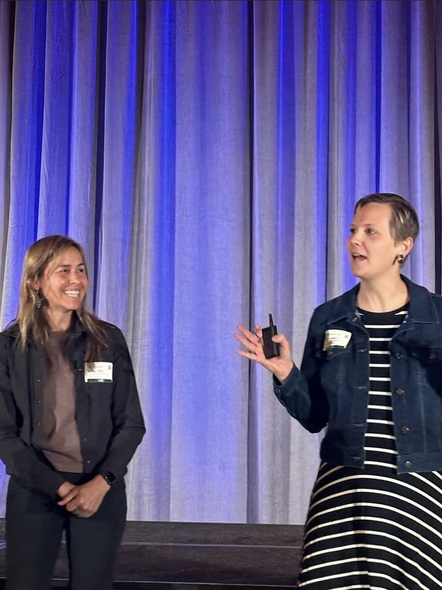 Member speakers presenting on stage during a Mastery.org event