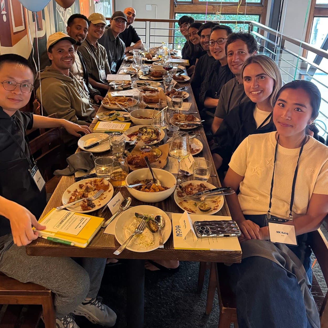 Members and the Mastery.org team at a long dinner table